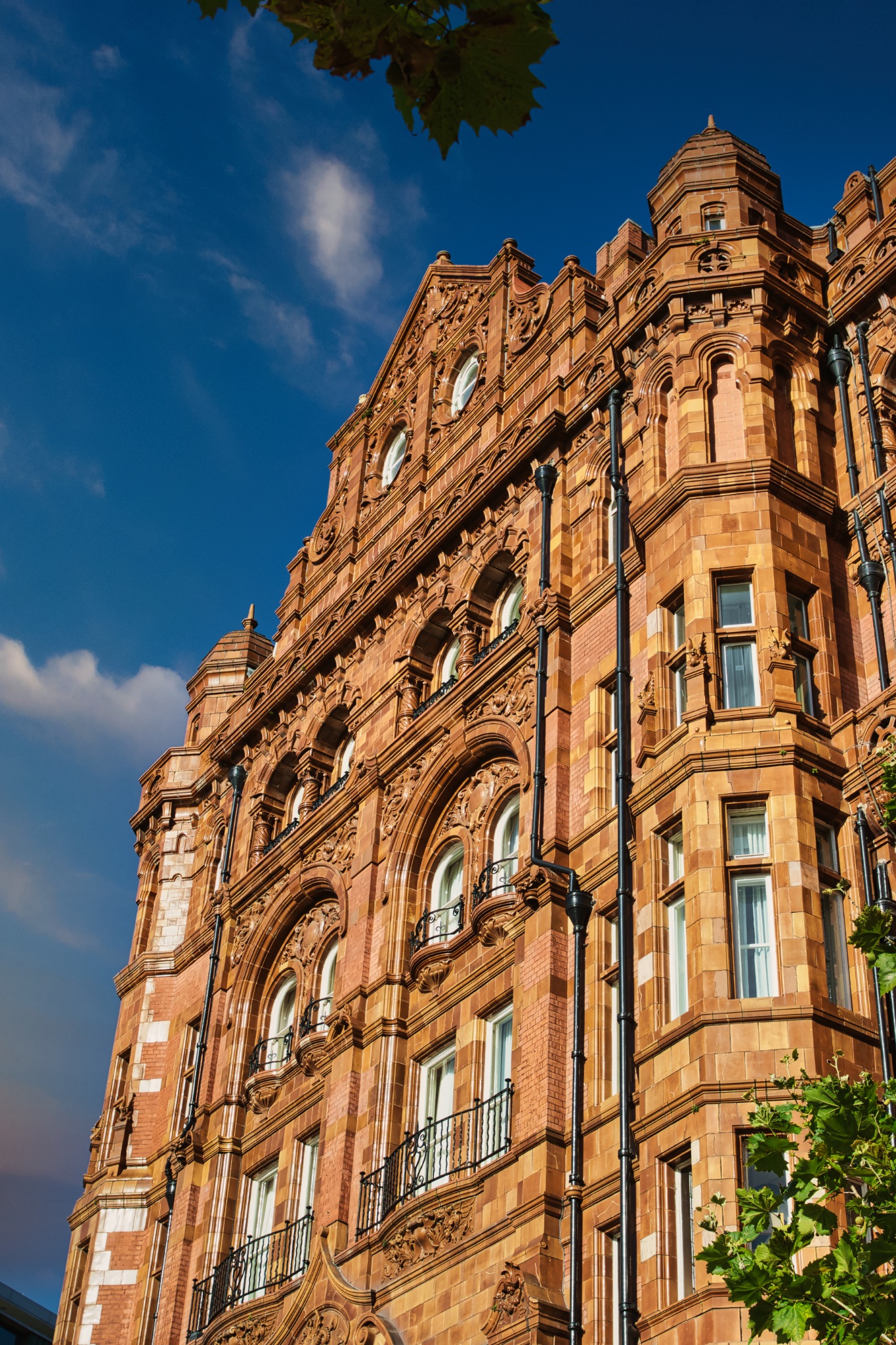 Ornate Red Brick Building with Multiple Windows in Manchester, UK.